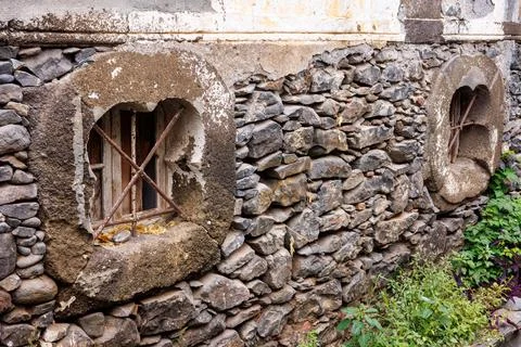Old basement windows with iron bars on a stone wall. Old walls made of ston.. Stock Photos