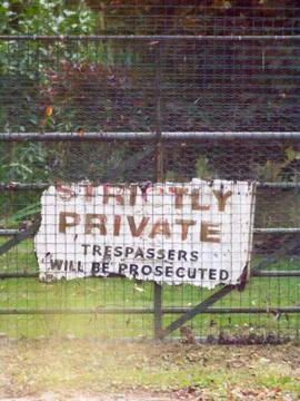 Old battered worn and weathered strictly private trespassers will be prosecut Stock Photos