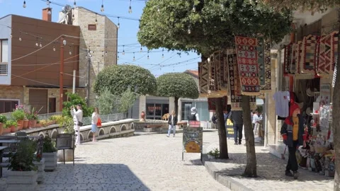 Old Bazaar of Krujë Cobblestone Lane with Tourists and Market Stalls Stock Footage 346343504