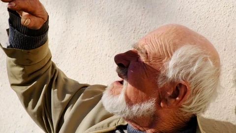 Old bearded man looking up at sunny day. Slow motion Stock Footage 127823725