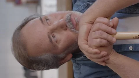 Old bearded man is thinking, leaning his head on his cane. Stock Footage 151996700