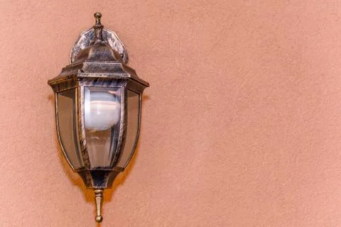 Old beautiful lantern an orange nice wall Stock Photos