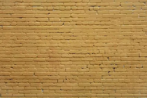 Old beige brick wall. rough surface texture Stock Photos