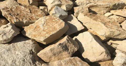Old beige stone wall background texture close up, wall stone. Stock Photos