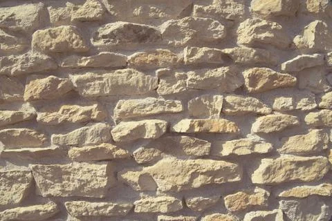 Old beige stone wall. Stock Photos