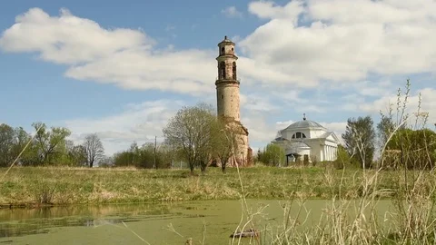 The old bell tower and the temple by the pond under the shadows of clouds Stock Footage 90194297