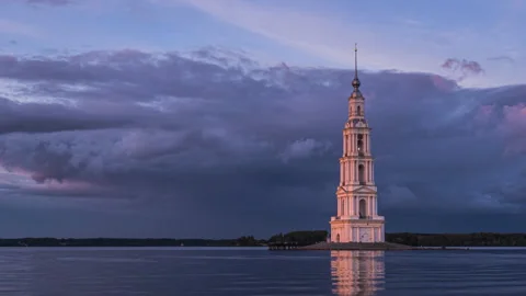 Old bell tower in the middle of the lake. Dramatic evening cloudy sky Stock Footage 255520872