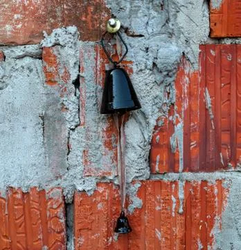 Old bell used on cattle, hanging on wall Foto stock