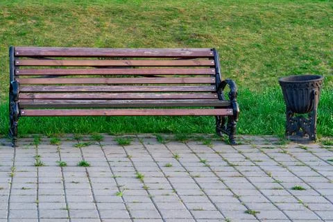 Old bench and garbage can for garbage closeup in the park Stock Photos