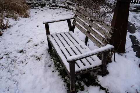 Old bench covered in snow Stock Photos