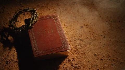 Old Bible and crown of thorns on dusty surface.  Shot with RED 8K camera. Stock Footage 130357293