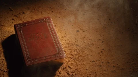 Old Bible on dusty surface.  Shot with RED 8K camera. Stock Footage 130357273