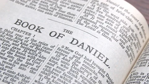 Old bible open to the book of Daniel Stock Footage 166850383