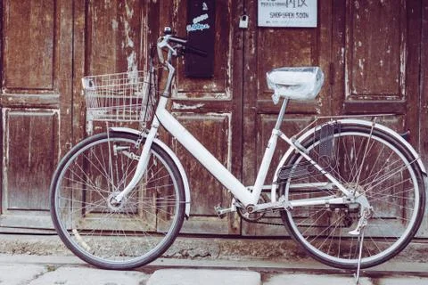 Old bicycle in front of the store in the morning. Stock Photos
