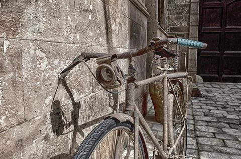 Old bicycle leaned on facade. Stock Photos