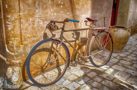 Old bicycle leaned on facade. Stock Photos