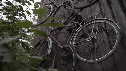 Old bicycles hang on the wall - Cine4 Stock Footage 101347692