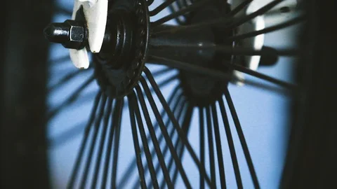 Old bike's front wheel and spokes slowly turn before coming to a stop. Video stock 100341416