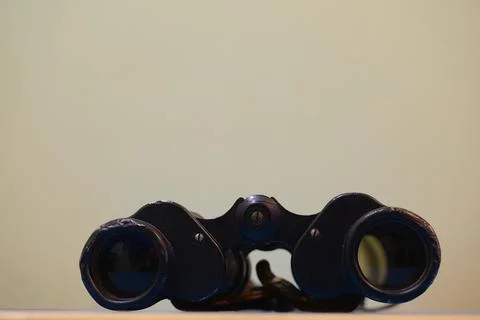 Old binoculars on the table close-up. Stock Photos