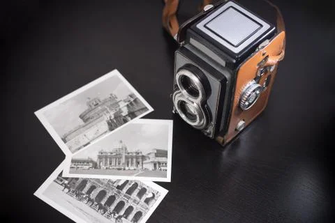 Old biooptic camera and old black and white pics Stock Photos