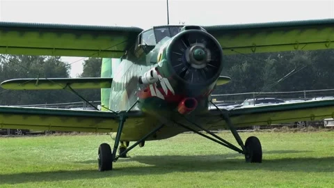 Old biplane on a grass runway. Stock Footage 145374985