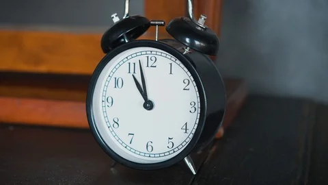 Old black and white clock on an empty table Stock Footage 119455300
