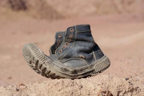 Old black boot in desert Photos