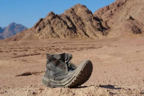 Old black boot in desert Stock Photos