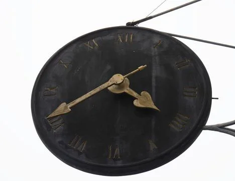 Old black clock with Roman numerals, white background 스톡 사진