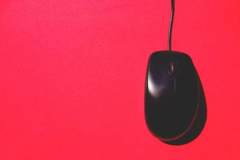 Old black computer mouse on red background Stock Photos