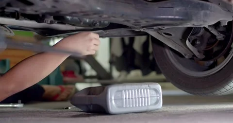 Old black engine oil was flowing from the oil change point. Stock Footage 277843843