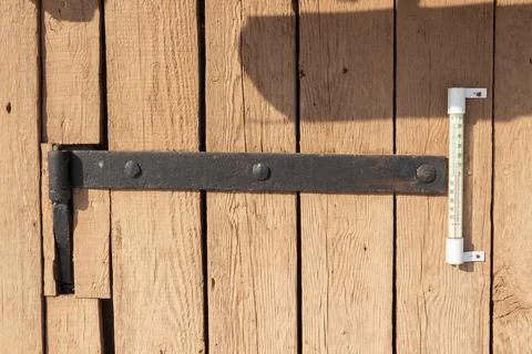 Old black hinge with ancient nails. Old brown wood planks Stock Photos