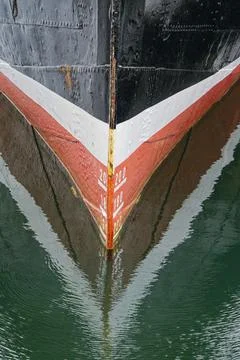 Old black ship bow with white and red bands and draft marks Stock Photos