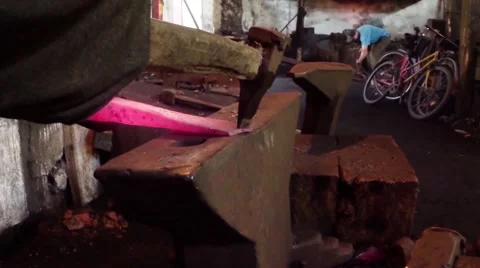 Old blacksmith forges metal piece on the anvil Stock Footage 46450018