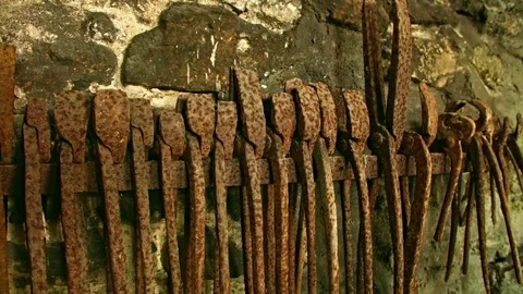 In an Old Blacksmith Rusty Tongs are on an Rack. Видео 80715816