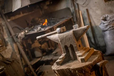 Old blacksmiths hammer on anvil in workshop read to be used for forging iron Stock Photos