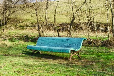 Old blue bench in the spring Park Stock Photos