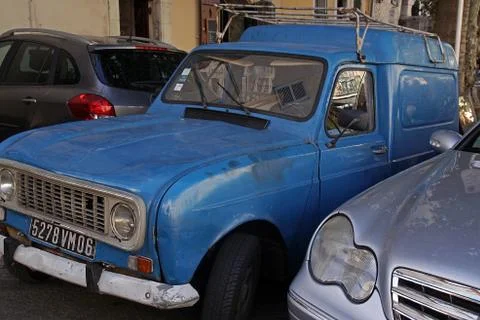 An old blue car between two new silver and gray cars. Rampe des Saleurs, Anti Stock Photos