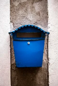 Old blue mailbox mounted on a wall Stock Photos