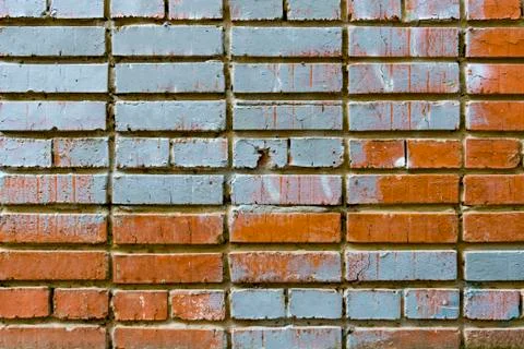 Old blue orange brick wall texture for background. Texture of a cracked two-tone Фото