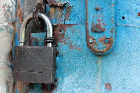 Old blue rustic door with rusty lock and keyhole Stock Photos