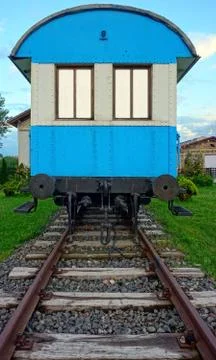 Old blue wagon on rails with empty windows Stock Photos