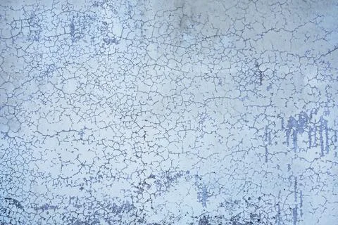 Old blue wall with small cracks and spots of dark paint. rough surface textur Stock Photos