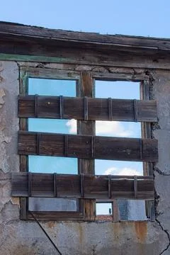 An old boarded up window in the ghost town of Jerome, Arizona. Stock Photos