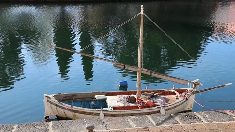 Old boat berthed in the river Stock Footage