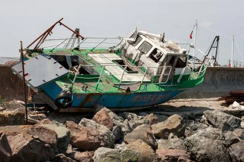 Old boat, large, powerful rusting wreck on sand Stock Photos