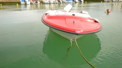 The old boat rocking on the waves in the Harbor Stock Footage 60601933