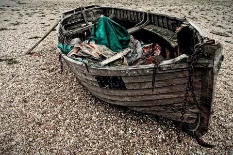 An old boat on a shingle beach Stock Photos