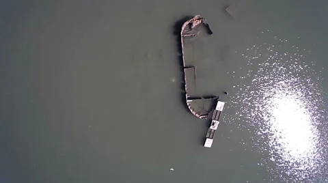 Old Boat Wreck Aerial Pulling Away with Sun Reflection Stock Footage 37032901