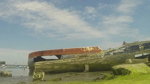 Old boats tide coming in and clouds 02 Stock Footage 33889853